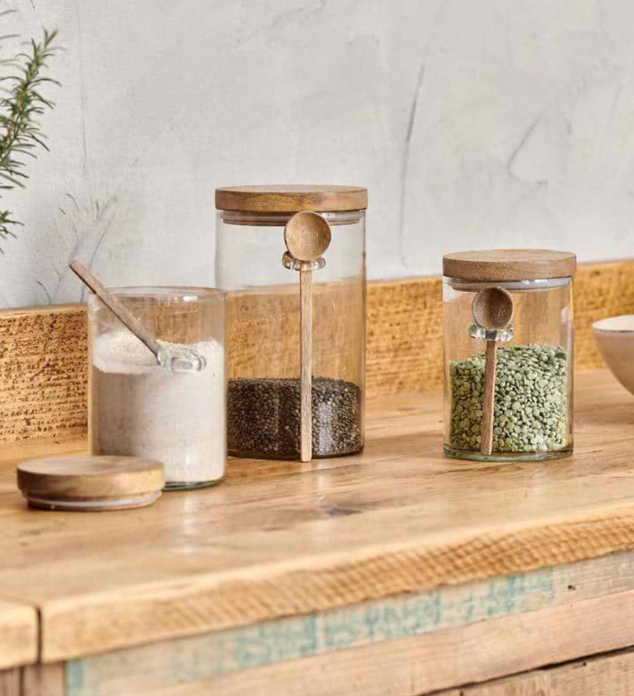 Small Nkuku Kossi Storage Jar with a ceramic body and wooden lid, ideal for kitchen or pantry storage.