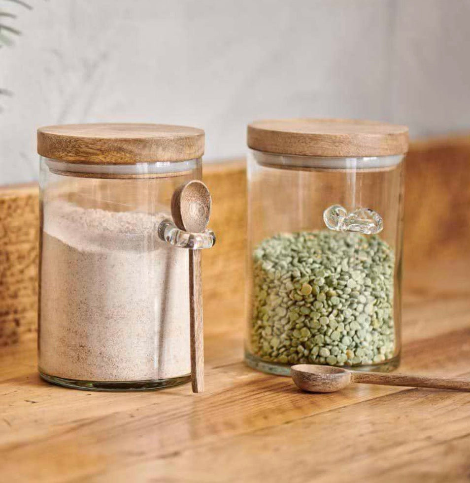Small Nkuku Kossi storage jar with a natural ceramic finish and wooden lid, perfect for kitchen organization.