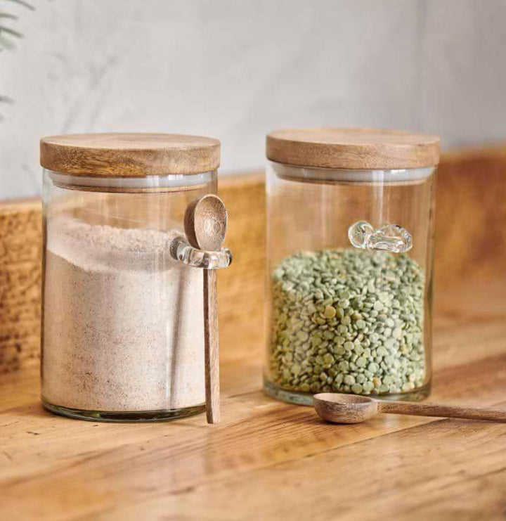 Small Nkuku Kossi storage jar with a natural ceramic finish and wooden lid, perfect for kitchen organization.