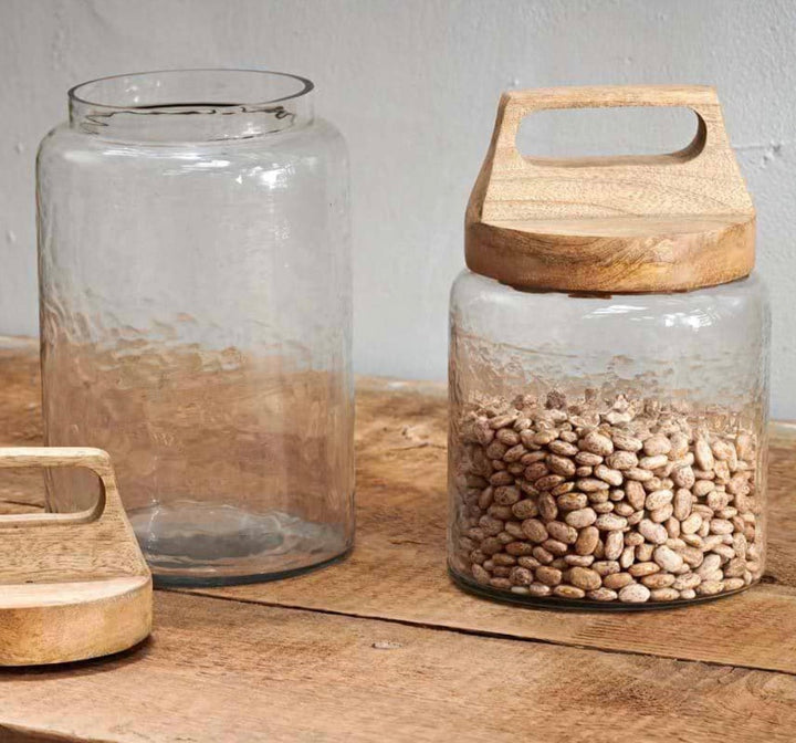 Large Nkuku Kitto Storage Jar with a clear glass body and wooden lid, ideal for kitchen storage and organization.