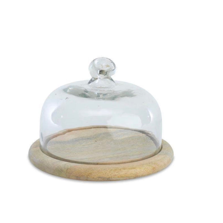 Clear Nkuku recycled glass cake dome with a rounded shape and open base, showcasing elegant, eco-friendly design.