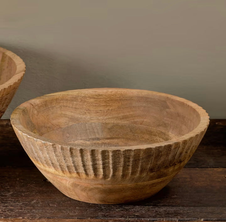 Small Gavivi mango wood bowl by Nkuku with a natural finish, showcasing smooth, rounded edges and a rustic wood grain appearance.