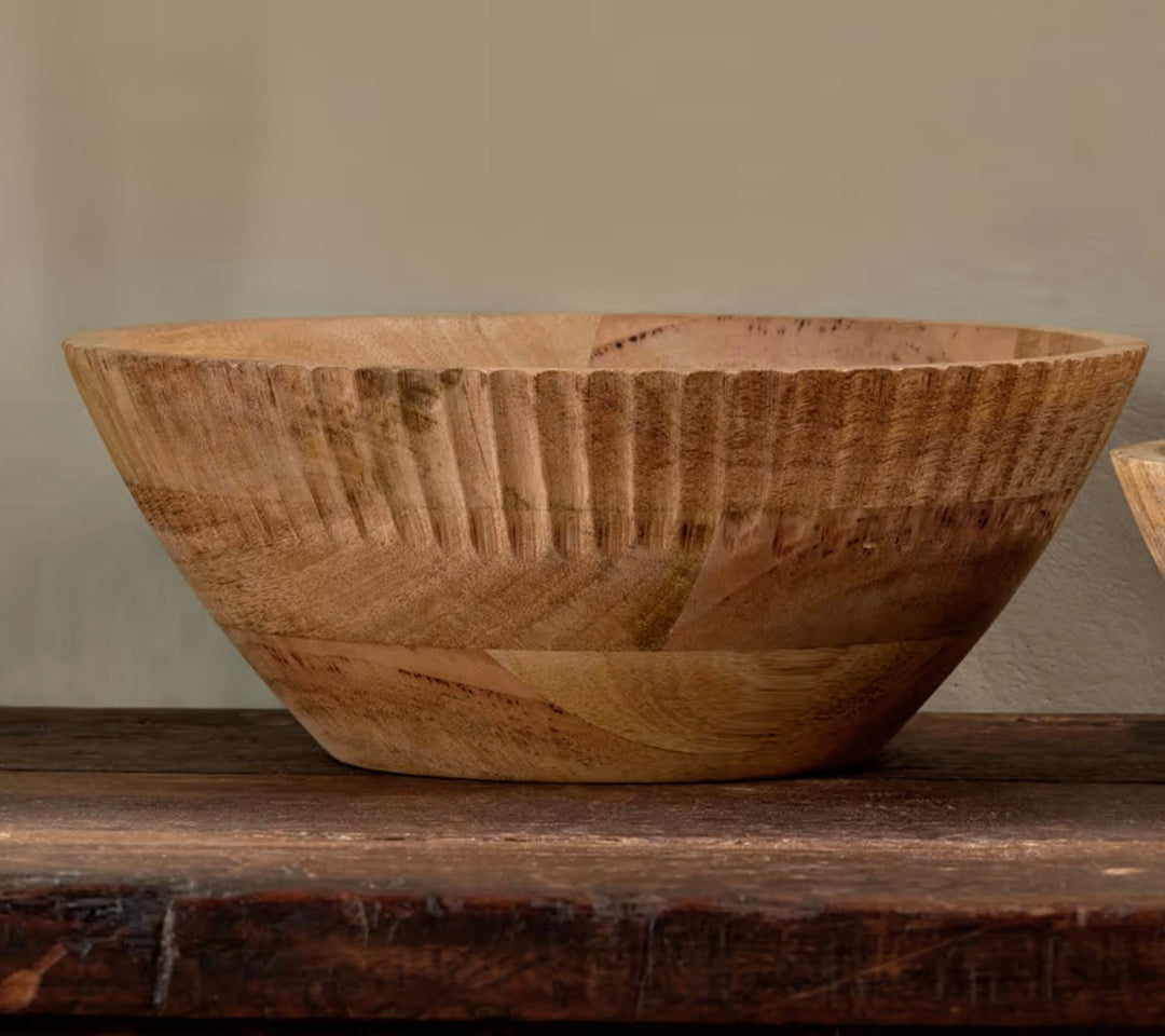 Small Nkuku Gavivi mango wood bowl in natural finish, showcasing smooth, rounded edges and handcrafted craftsmanship.