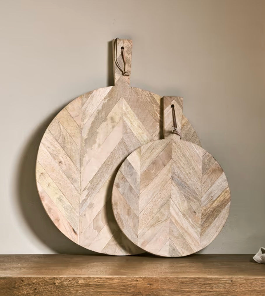 Small Nalbari pizza board by Nkuku, made from mango wood, showcasing a smooth, natural finish for serving pizza.