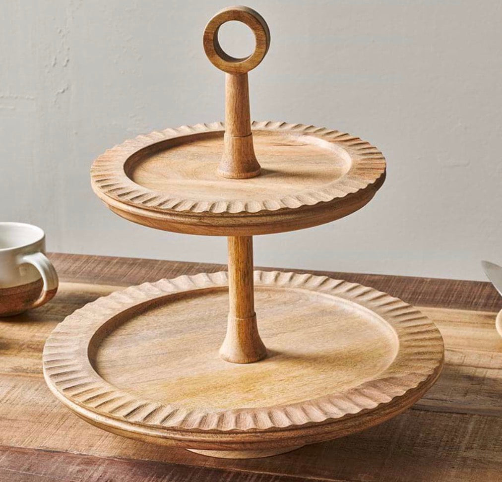 Nkuku Gavivi mango wood cake stand with a smooth, round surface and sturdy base, perfect for serving desserts or displaying baked goods.