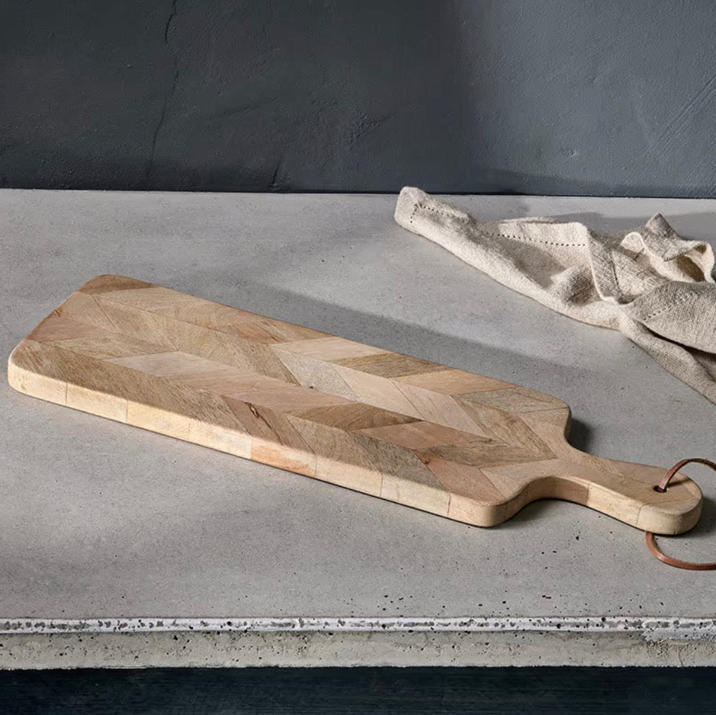 Nkuku Nalbari chopping board made of wood, featuring a smooth surface and natural grain for kitchen prep and serving.