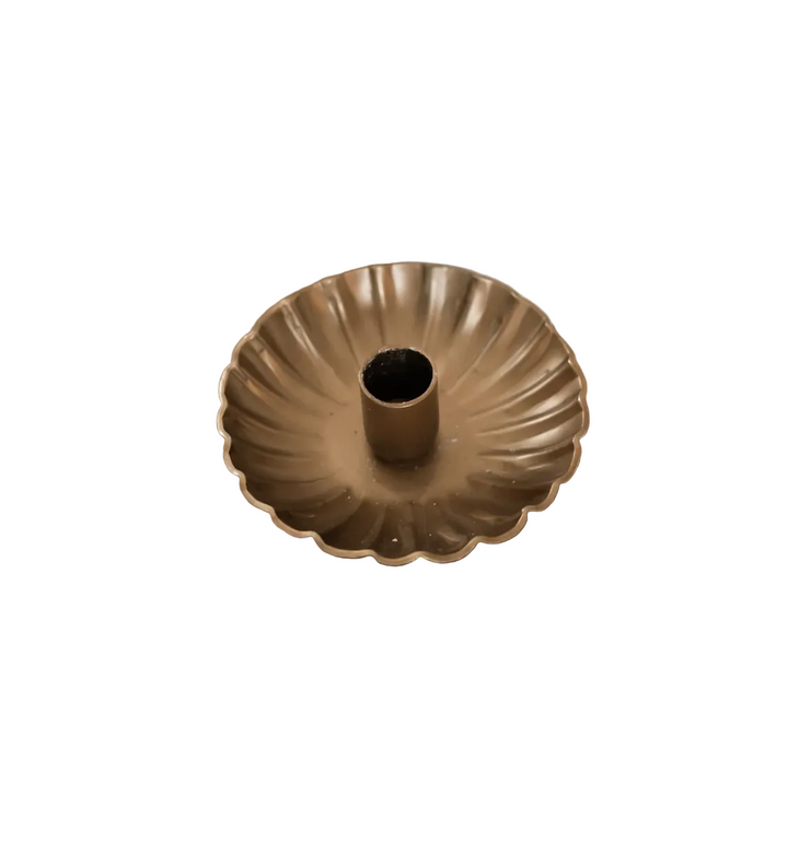 Gold decorative bowl on a wooden surface with a blurred background