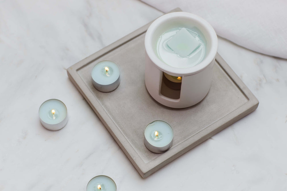 Stoneglow Sea Salt and Oakmoss fragranced tealights in glass holders, perfect for creating a relaxing ambiance.