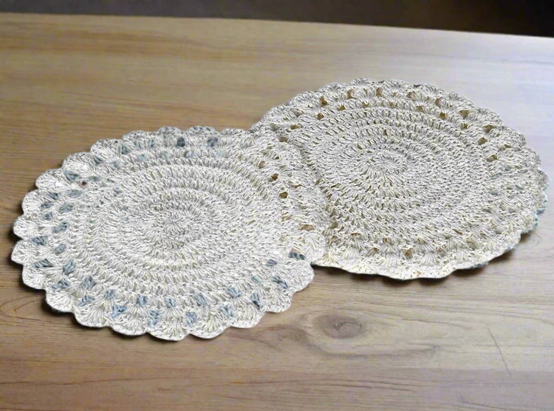 Set of 2 white crochet placemats by Coach House from Cornucopia Home and Gift, featuring intricate crochet patterns on a flat surface.