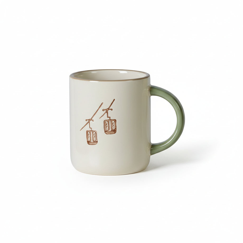 Beige Coach House Christmas Ski Lift mug by Cornucopia Home and Gift featuring a winter ski lift design.