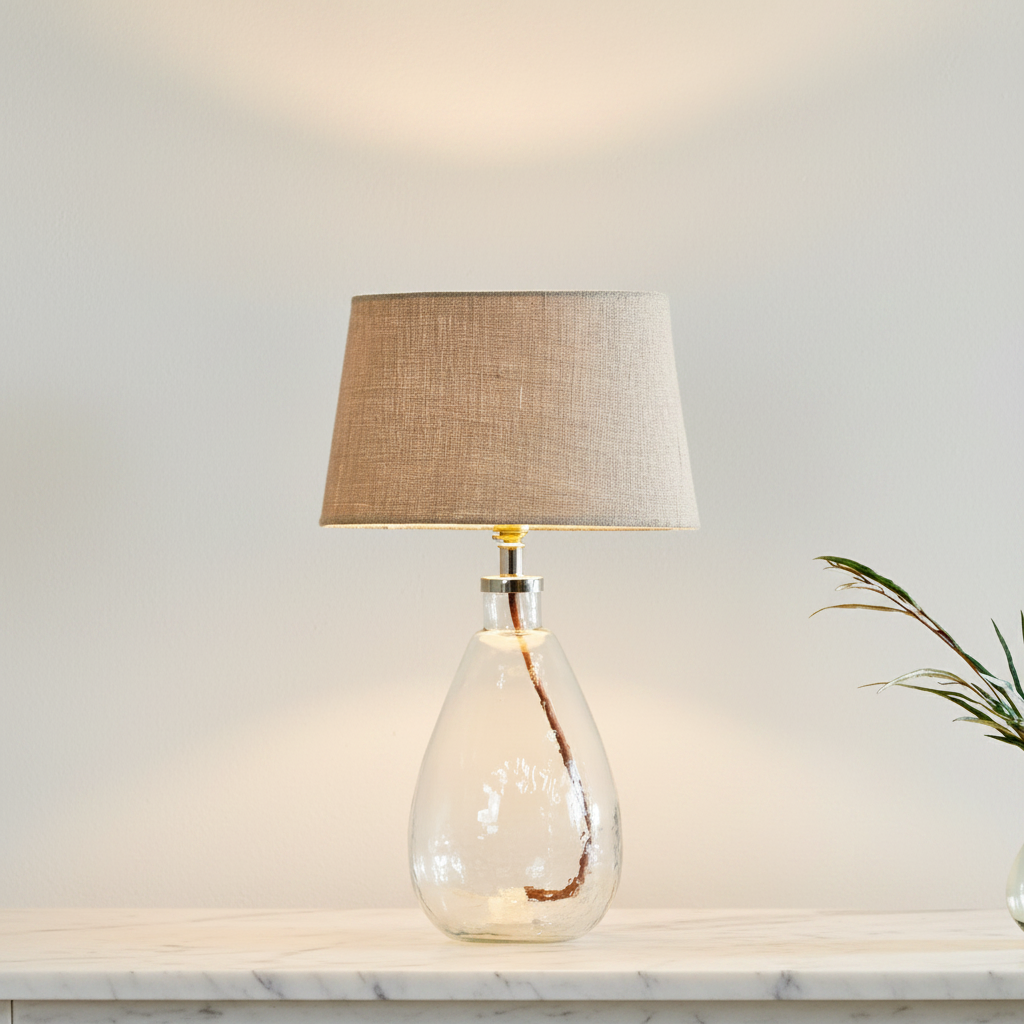 Small tall clear Baba glass lamp by Nkuku with a sleek, minimalist design, perfect for modern home decor.