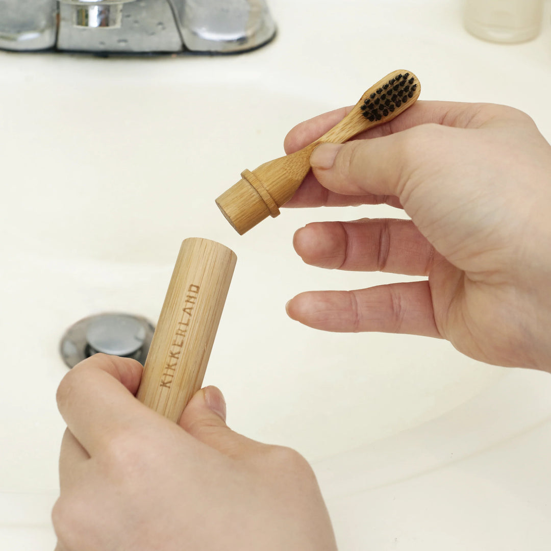 Kikkerland on-the-go bamboo toothbrush with biodegradable handle and soft bristles, ideal for eco-friendly travel and daily use.