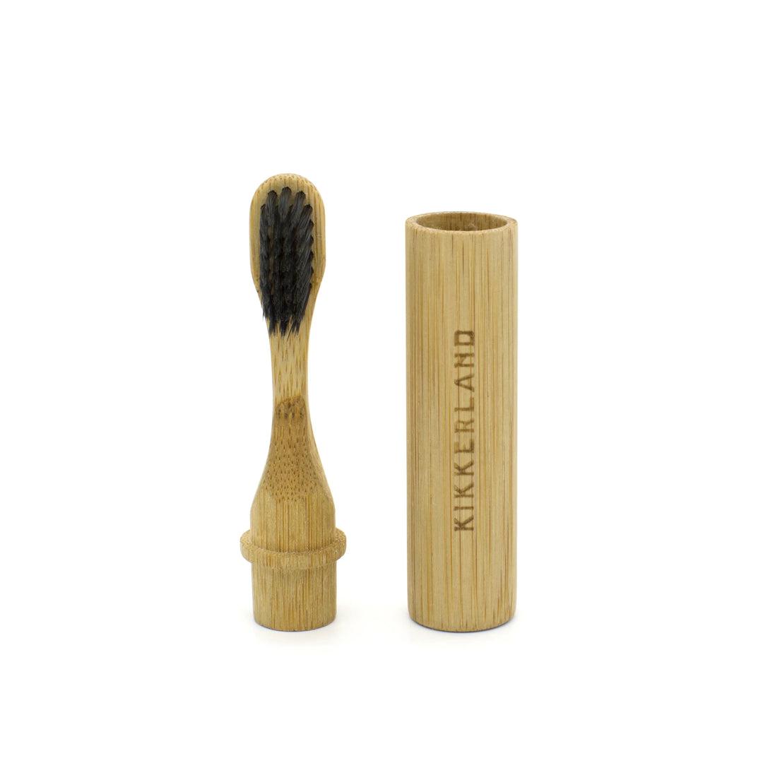 Kikkerland on-the-go bamboo toothbrush with biodegradable handle, suitable for travel and eco-friendly oral care.