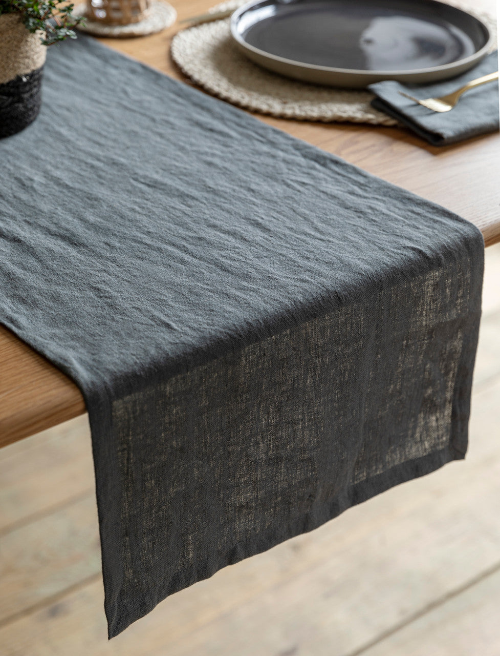 Charcoal linen table runner by Garden Trading, featuring a natural textured fabric perfect for elegant dining settings.