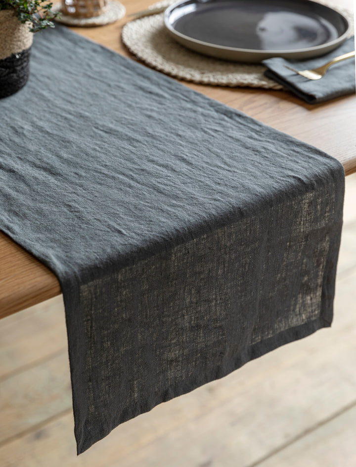 Charcoal linen table runner by Garden Trading, featuring a natural textured fabric perfect for elegant dining settings.