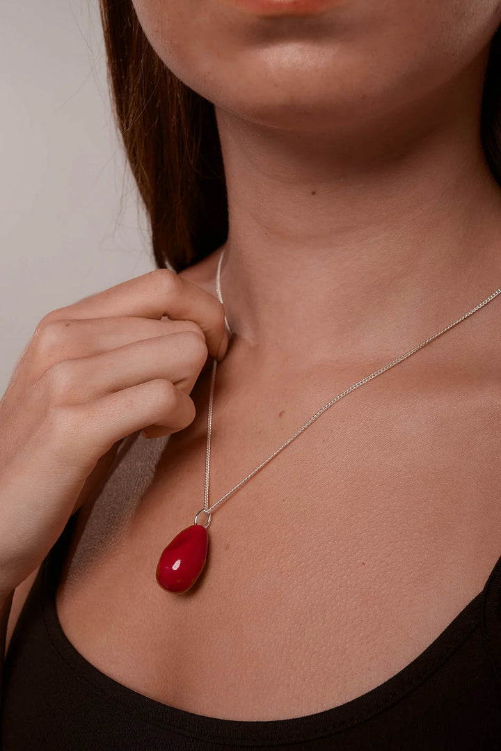 Red enamel Kew necklace by Tutti &amp; Co featuring a vibrant floral pendant, styled on a delicate chain.