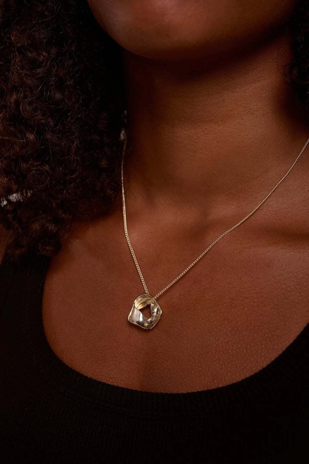Gold Soho Necklace by Tutti &amp; Co featuring a delicate chain and stylish pendant, displayed on a neutral background.