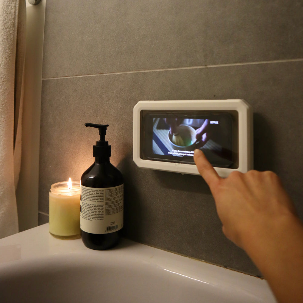 Kikkerland shower proof phone case by Cornucopia Home and Gift, waterproof design protecting a smartphone from water damage.