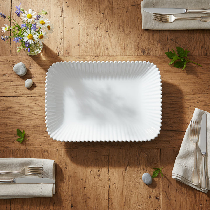 White rectangular plate with a textured rim on a white background