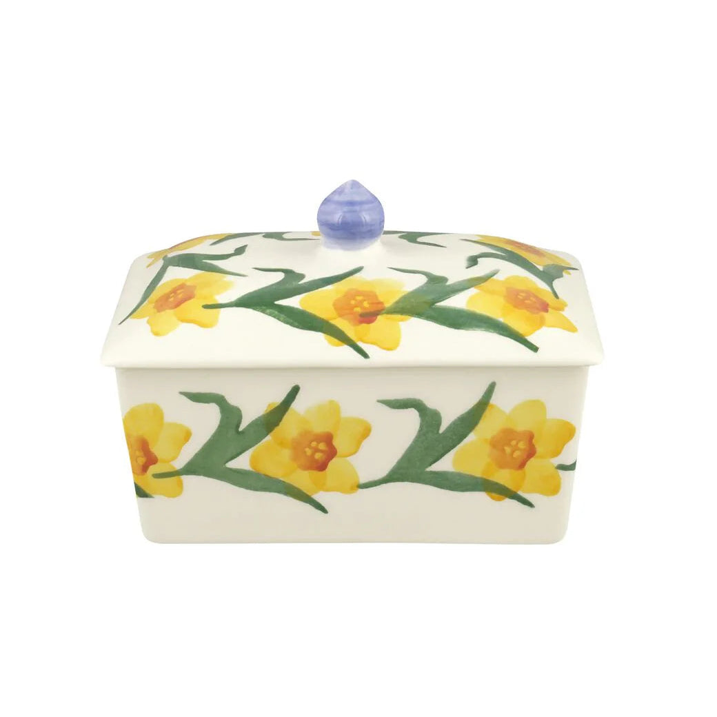 Ceramic butter dish with daffodil design on a white background