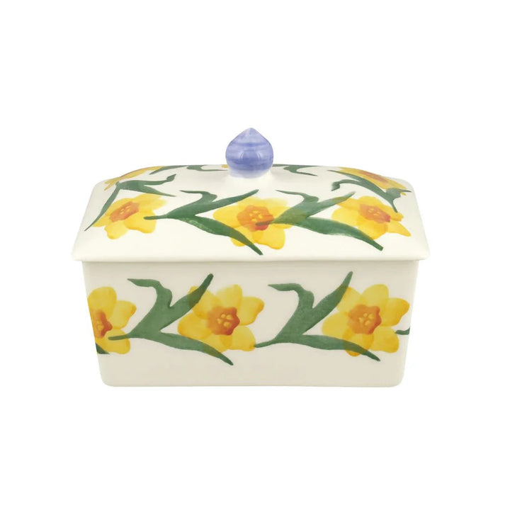 Ceramic butter dish with daffodil design on a white background