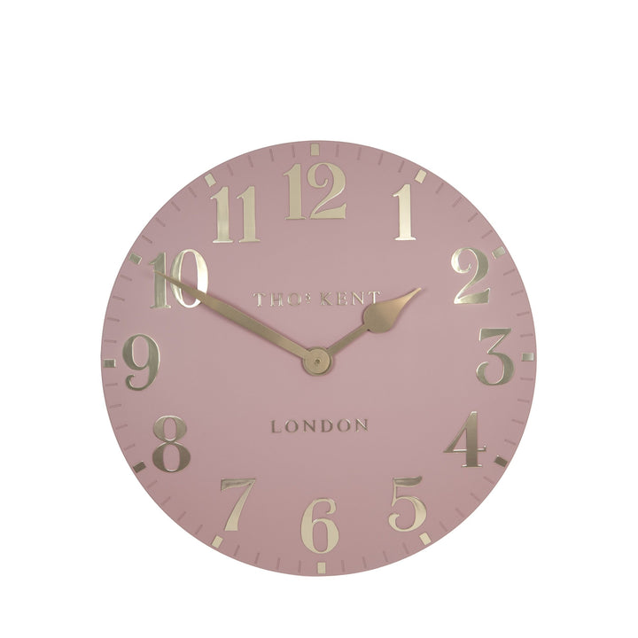 12-inch blush pink Arabic wall clock by Cornucopia Home and Gift with black Arabic numerals and modern design.