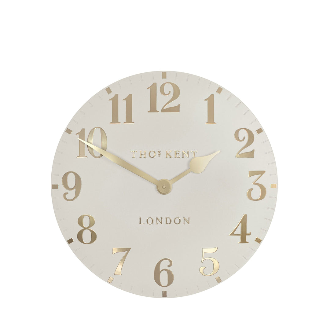 12-inch Arabic wall clock in oatmeal color by Cornucopia Home and Gift, featuring modern Arabic numerals and a sleek design.
