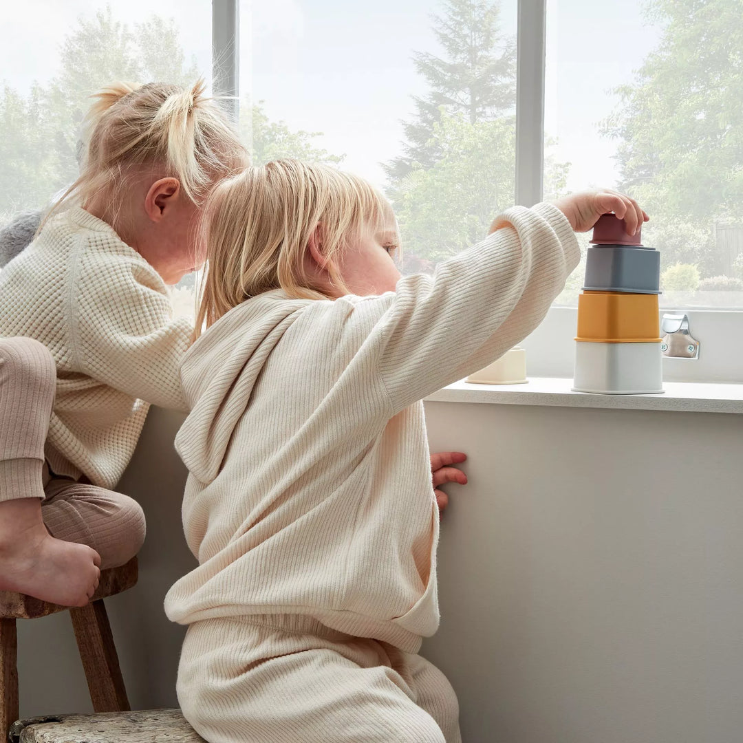 Colorful Bambino Silicone Stacking Cups by Widdop & Co for Cornucopia Home and Gift, arranged in a stack with vibrant hues.
