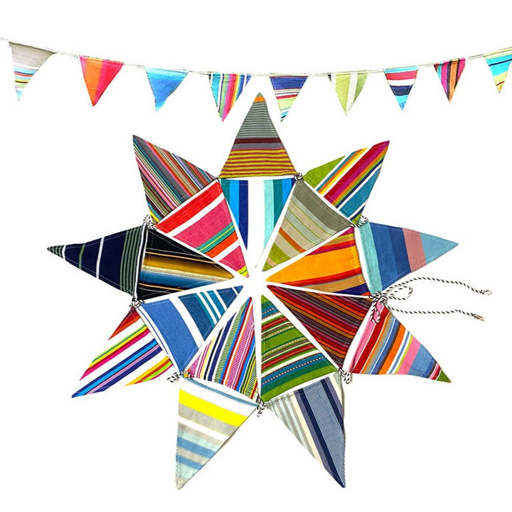 Gisela Graham multi-striped bunting with colorful fabric triangles hanging in a festive display.