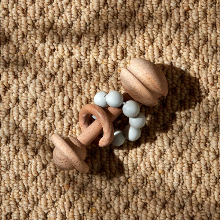Grey wooden teething rattle toy by Widdop &amp; Co from Cornucopia Home and Gift, showing smooth, rounded wooden beads and a teething-friendly design.