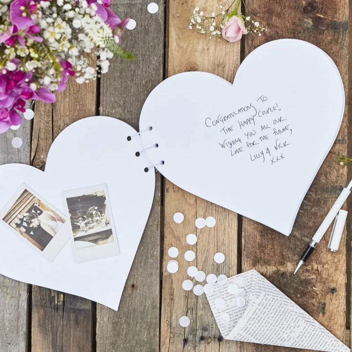 Heart-shaped Ginger Ray guestbook with kraft cover, featuring floral and heart designs, from Cornucopia Worcester.