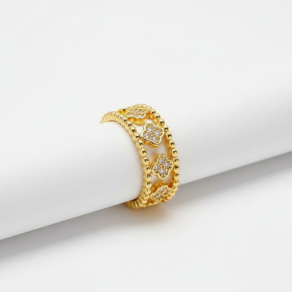 White leaf-shaped gold multi-flower ring with intricate floral details, crafted by Cornucopia Home and Gift.
