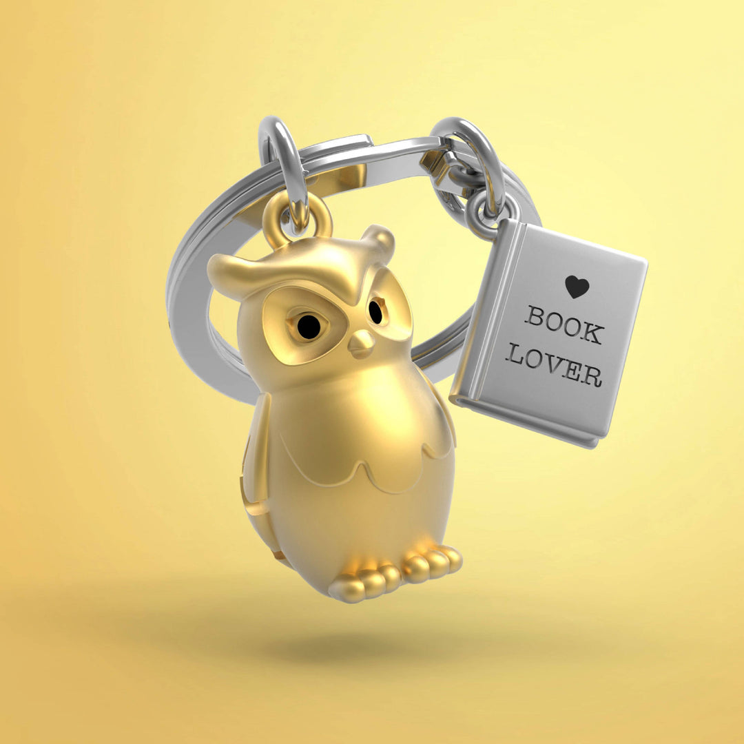 Gold owl and book keyring by Oli Olsen featuring a detailed owl charm and a miniature book, perfect for keys or accessories.