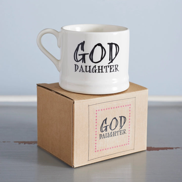 Sweet William God Daughter Mug featuring a heartfelt design, perfect for gifting and showcasing on a kitchen shelf.