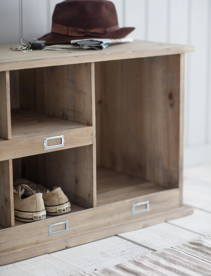 Natural Chedworth Welly Locker low by Garden Trading in a garden setting, showcasing its wooden construction and functional design.