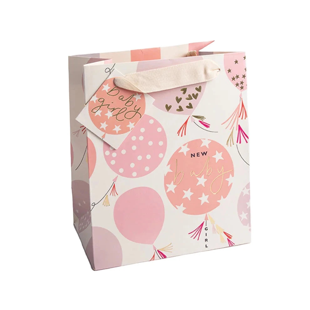 Caroline Gardner baby girl balloons medium gift bag with colorful balloon illustrations and playful design.