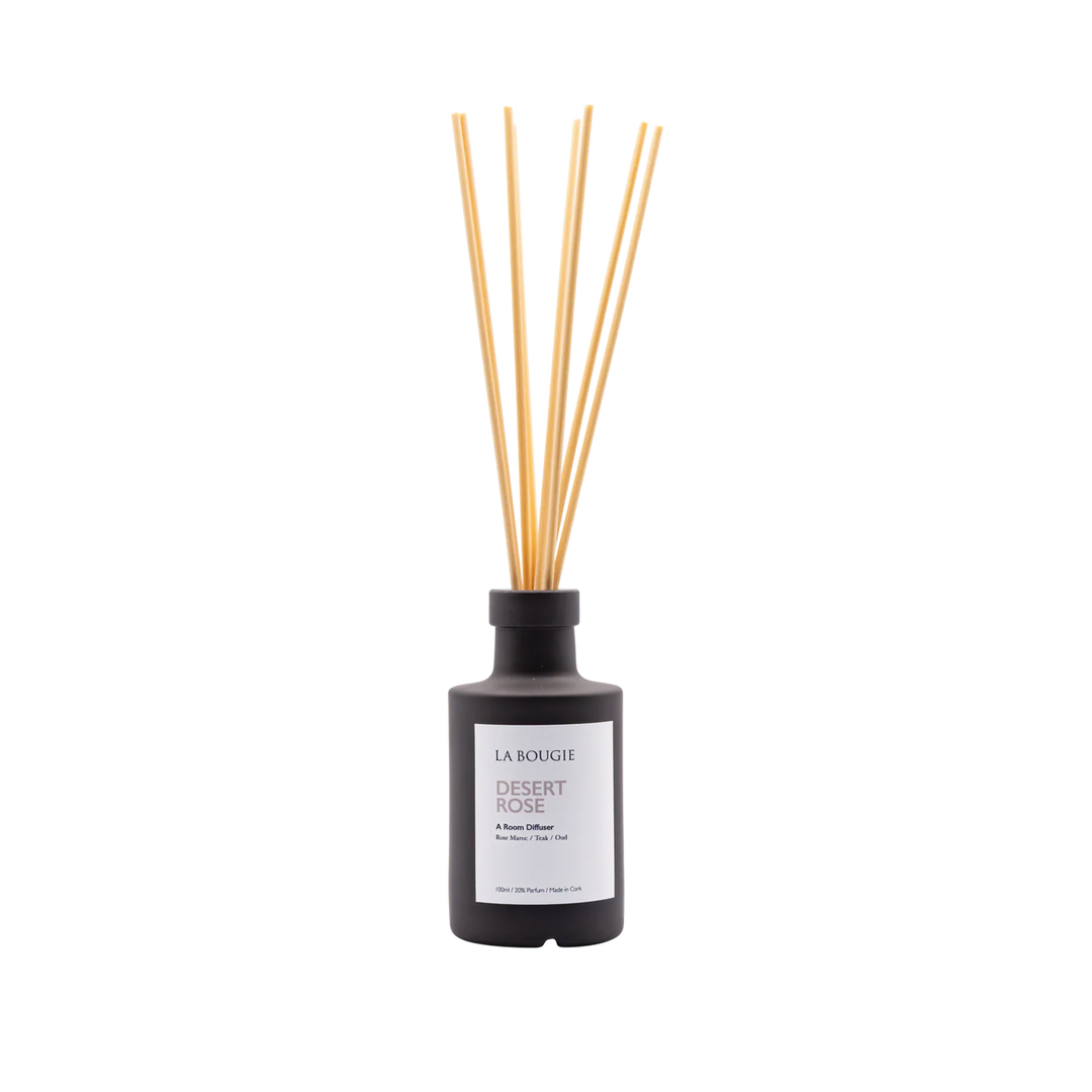 Cornucopia Home Desert Rose Room Diffuser with elegant glass bottle and reed sticks for continuous floral fragrance.