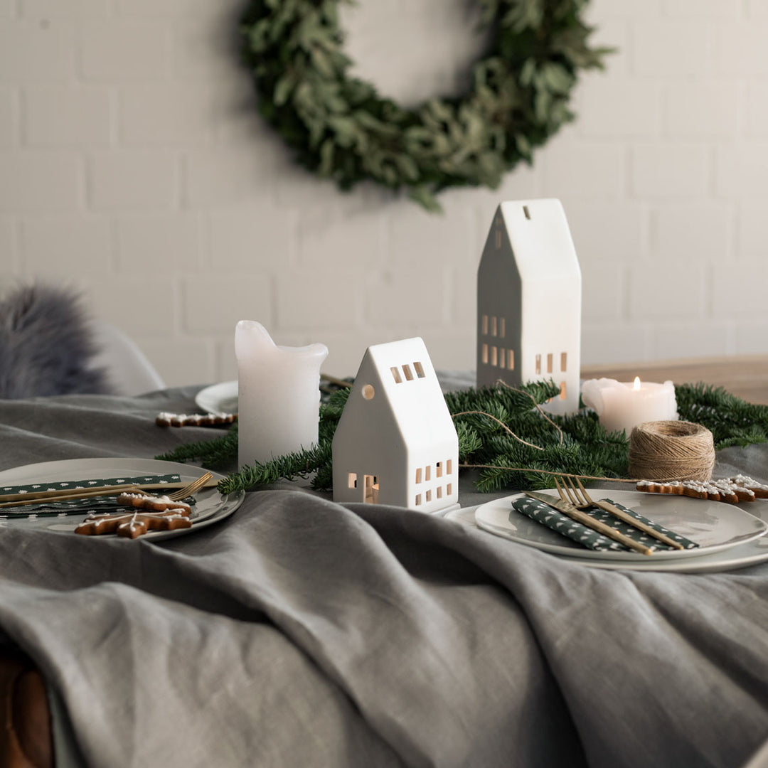 Small porcelain lighthouse radër by Cornucopia Home and Gift with intricate detailing and a lighthouse design.