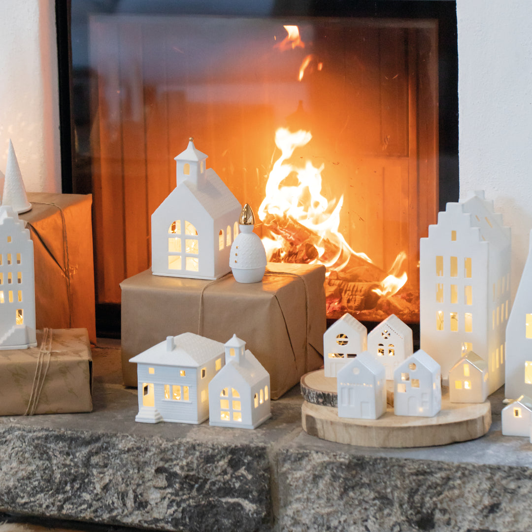 Porcelain lighthouse figurine by Cornucopia Home and Gift, detailed city villa design with intricate painted features.