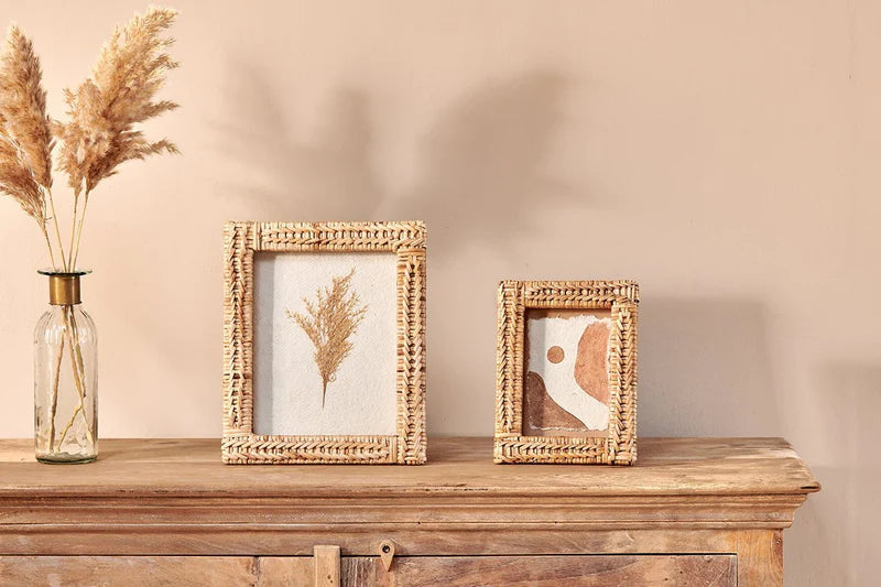 Nkuku Yanis rattan photo frame with natural woven design, perfect for displaying cherished photographs in a stylish home decor setting.