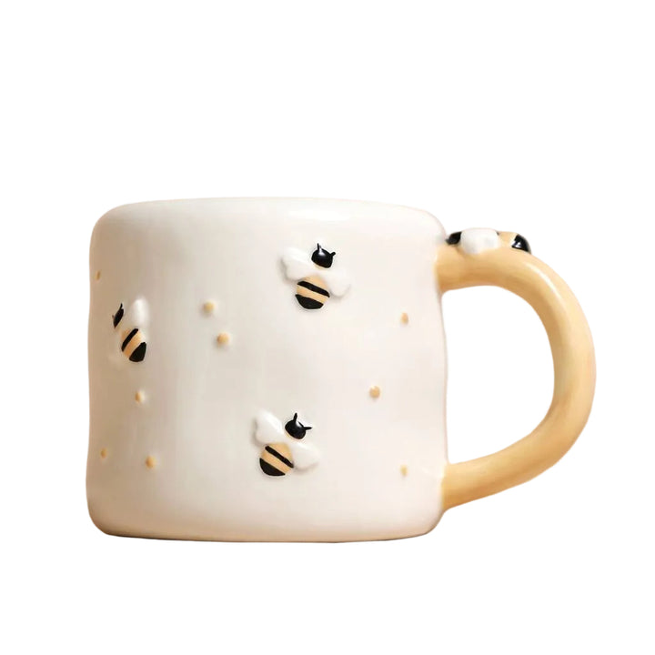 Irregular ceramic bee mug by Lisa Angel with a textured, handcrafted design perfect for tea or coffee.