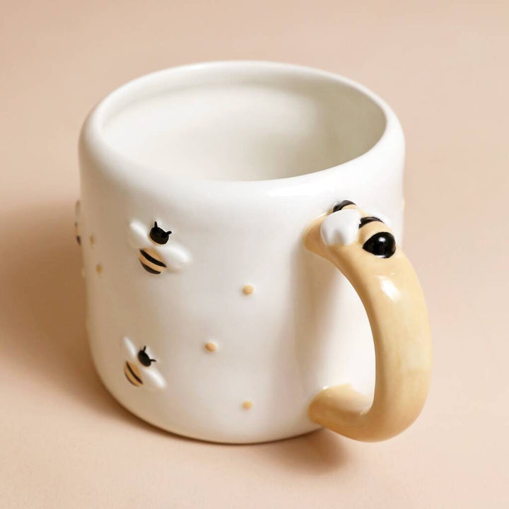 Irregular ceramic bee mug by Lisa Angel featuring a whimsical bee design, perfect for coffee or tea.