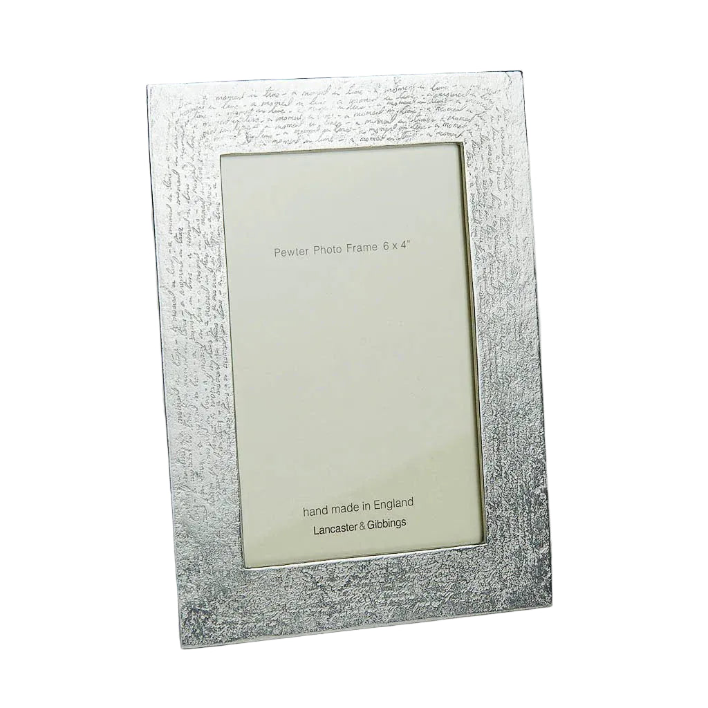 Silver photo frame with textured surface on a gray background