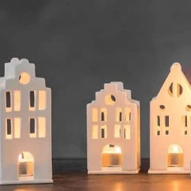 Radër Small Tea Light House by Cornucopia Home and Gift, featuring a charming miniature house design with cutout windows and a tea light holder.