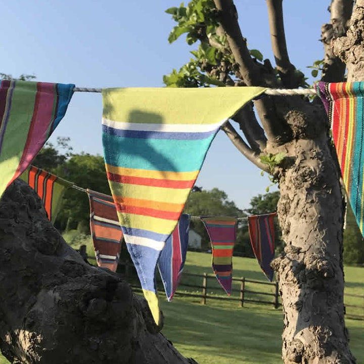 Colorful Gisela Graham multi stripe bunting with hanging fabric triangles for festive or decorative use.