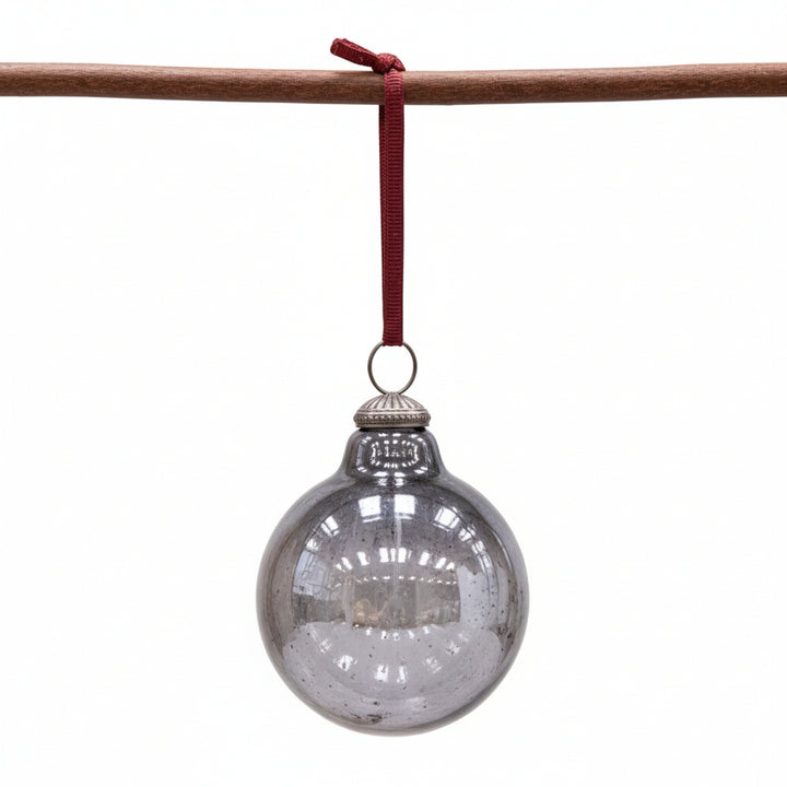 Nkuku Alura Round Bauble Smoke, a stylish glass ornament with a smooth, rounded shape and smoky finish, perfect for holiday decor.