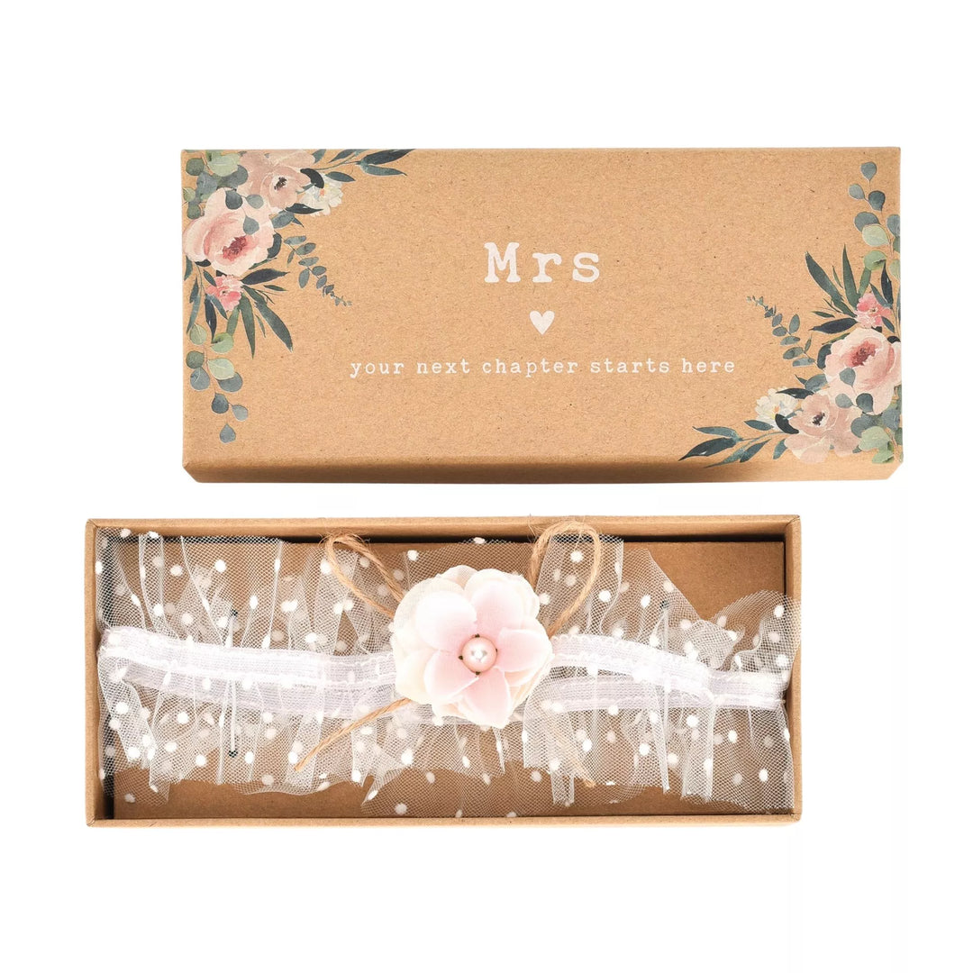 Ivory tulle wedding garter with white flower detail, crafted by Widdop & Co, for bridal accessories and wedding attire.