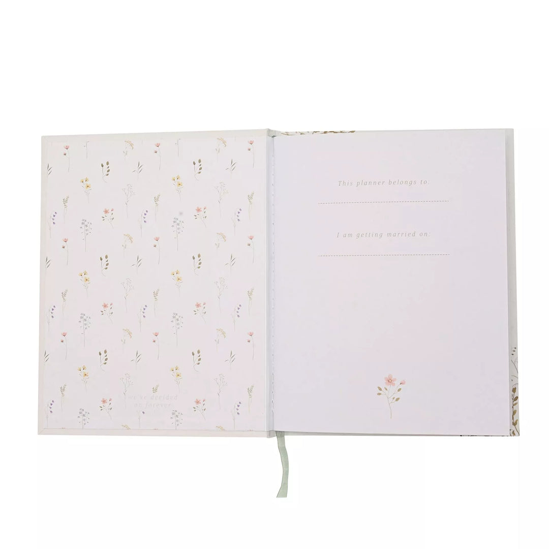 Wildflower wedding planner by Widdop &amp; Co featuring floral cover design and organized interior pages for wedding planning.