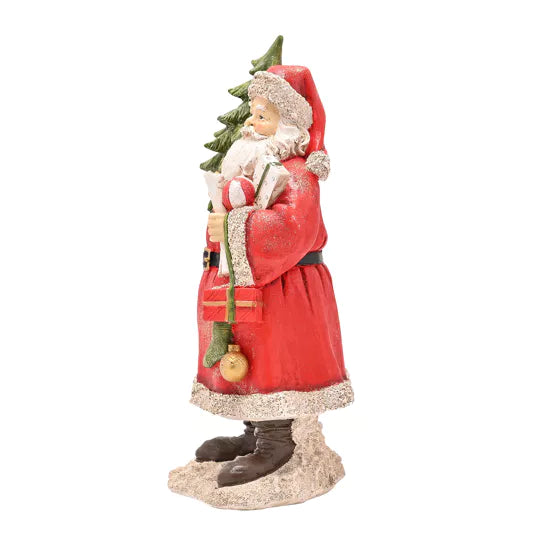 Father Christmas figure holding a Christmas tree from Widdop &amp; Co Cornucopia Home and Gift, festive holiday decoration.