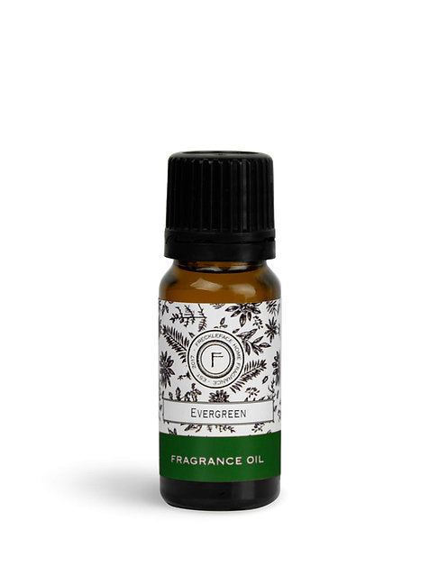Freckleface Evergreen diffuser oil by Cornucopia Home and Gift, showcasing a dark amber bottle and natural botanical elements.